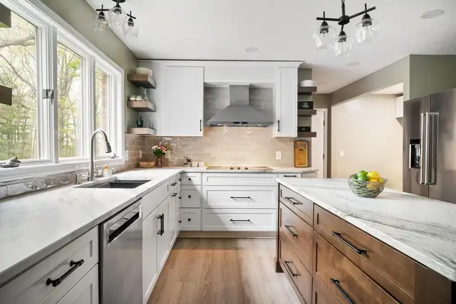 Preston Forest kitchen remodel in Blacksburg with white shaker cabinets, stained wood island, marble-look counters and tile backsplash